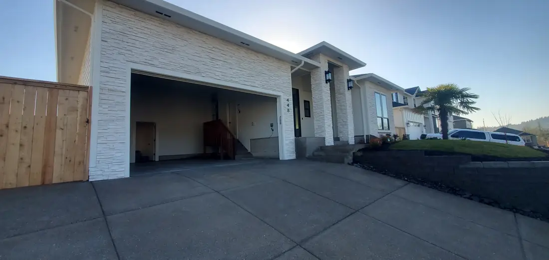 New construction home exterior with garage at dusk Oregon