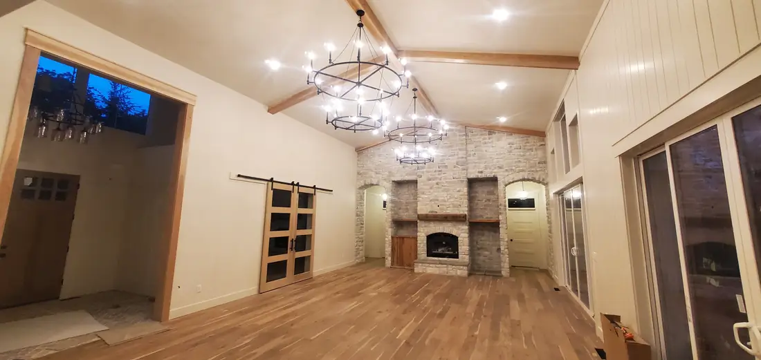 Brick veneer fireplace and TV nook with chandelier Oregon home
