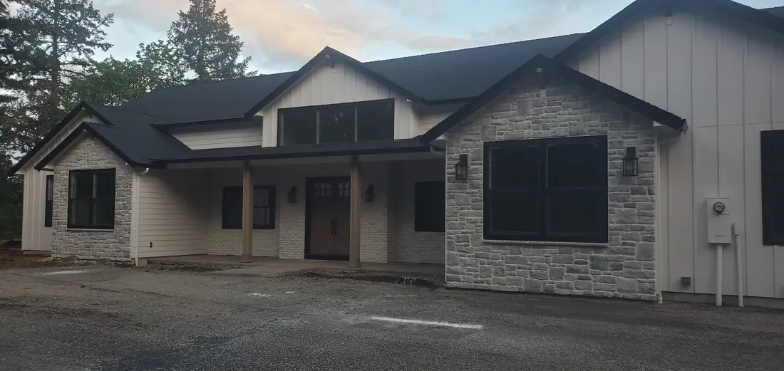 Farmhouse front exterior with stone veneer accents Oregon
