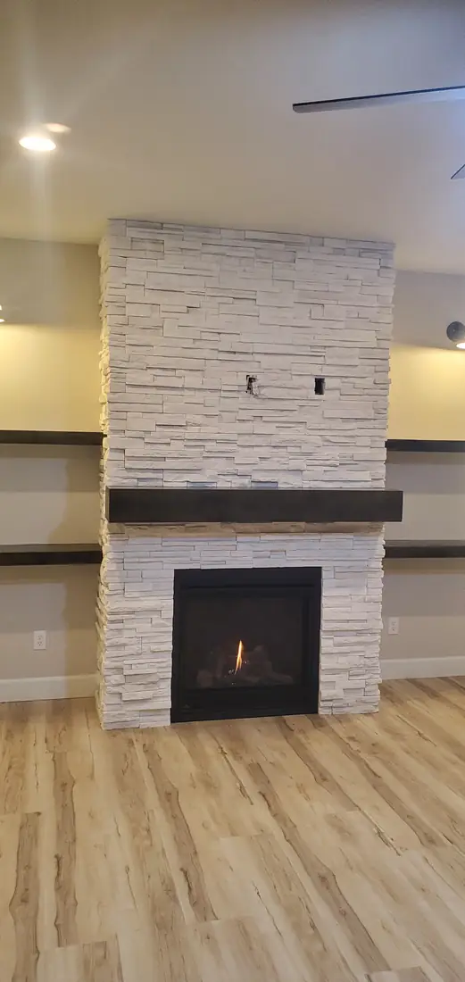 Tall white stacked stone veneer floor to ceiling fireplace Oregon