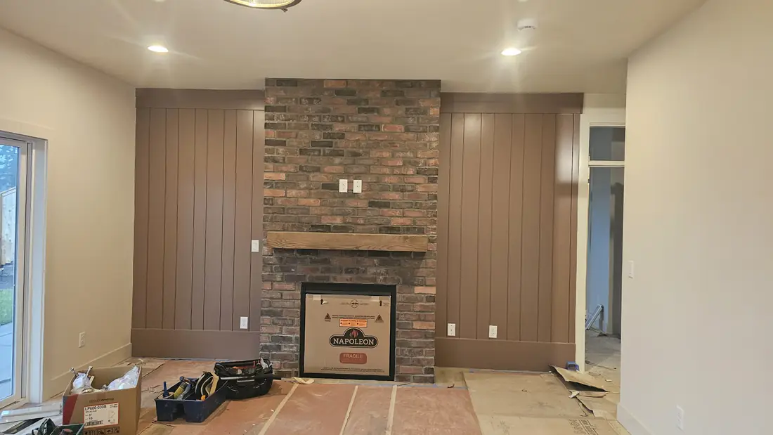 Brick veneer fireplace with wood accent wall in living room Oregon