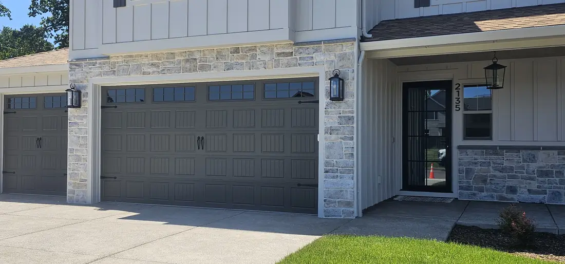 Modern farmhouse exterior with stone veneer and gray garage Oregon