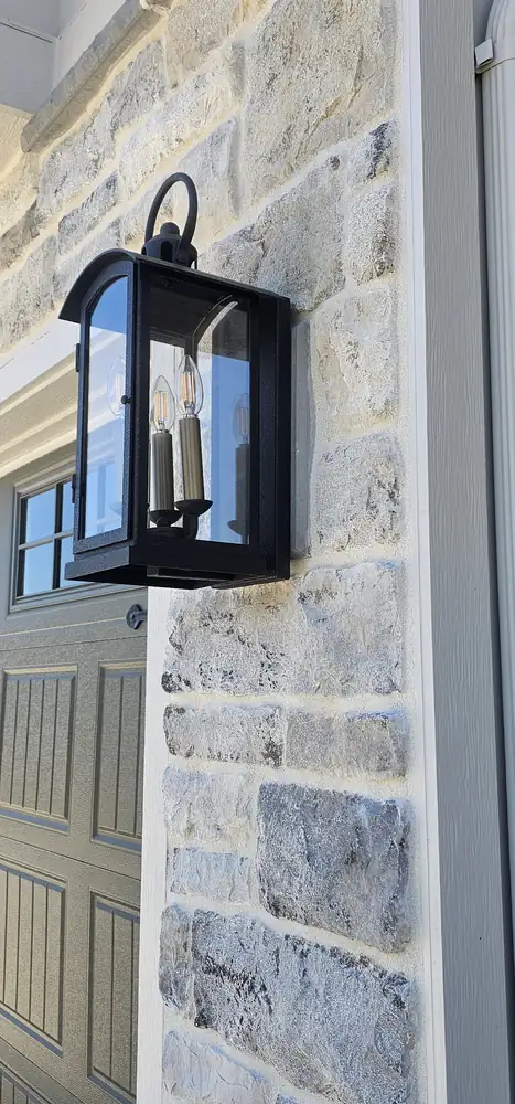 Stone veneer exterior wall with light fixture and board and batten Oregon